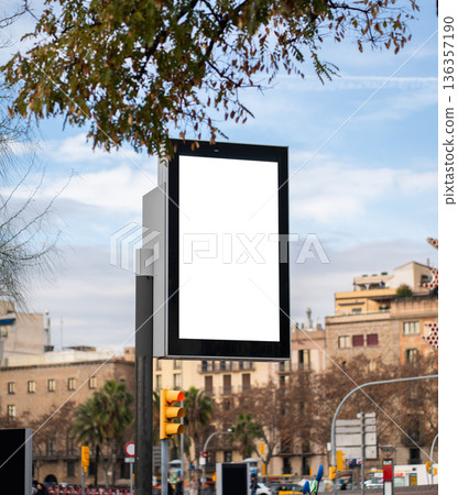 Vertical blank street billboard mockup with digital display and copy space for outdoor marketing along a Barcelona city street, framed by buildings, traffic light and sky Vertical blank street billboard mockup with digital display and copy space for outdoor marketing along a Barcelona city street, framed by buildings, traffic light and sky 136357190