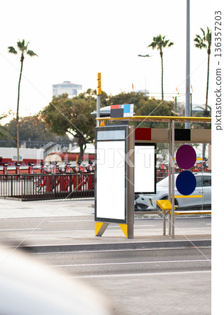 Bus stop advertising mockups in an urban setting with blank billboards offering copy space on a city street, showing modern public transport infrastructure and shared bikes Bus stop advertising mockups in an urban setting with blank billboards offering copy space on a city street, showing modern public transport infrastructure and shared bikes 136357203