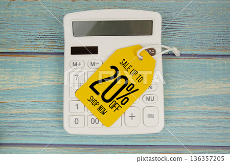 Sale up to 20% off Shop Now with price tag and calculator on wooden background Sale up to 20% off Shop Now with price tag and calculator on wooden background 136357205