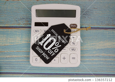 Special Discount 10% off Shop Now with price tag and calculator on wooden background Special Discount 10% off Shop Now with price tag and calculator on wooden background 136357212