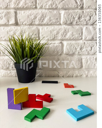 multicolored wooden puzzle pieces on a white table 136358065