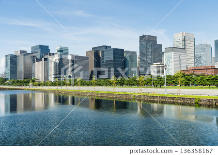 View of the Kokyo Gaien's Nijubashi Moat with the Marunouchi Modern office building in Chiyoda, Tokyo, Japan. Marunouchi is the core of the Tokyo central business district. View of the Kokyo Gaien's Nijubashi Moat with the Marunouchi Modern office building in Chiyoda, Tokyo, Japan. Marunouchi is the core of the Tokyo central business district. 136358167