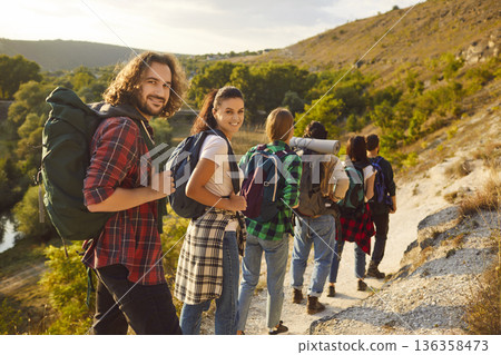 Group of travelers and friends traveling together in mountains and enjoying view of nature. Group of travelers and friends traveling together in mountains and enjoying view of nature. 136358473