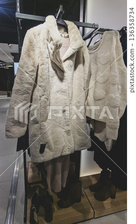 Cream knit sweater beside coat, cream cream aesthetic aligns color of year 2026, cream minimal luxury for retail displays, sustainable capsule wardrobe, branding visuals for fashion stores Cream knit sweater beside coat, cream cream aesthetic aligns color of year 2026, cream minimal luxury for retail displays, sustainable capsule wardrobe, branding visuals for fashion stores 136358734