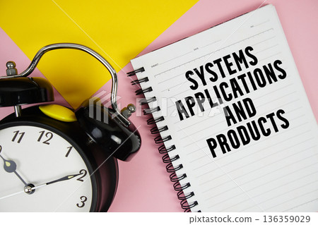 SAP Systems Applications and Products text written on notepad with alarm clock on pink background SAP Systems Applications and Products text written on notepad with alarm clock on pink background 136359029