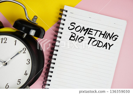 Something Big Today text written on notepad with alarm clock on pink background Something Big Today text written on notepad with alarm clock on pink background 136359030