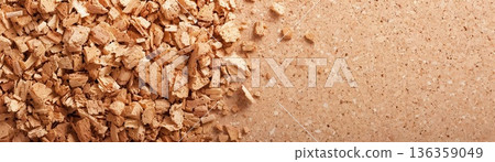 Close-up of brown wood chips scattered on a surface. 136359049