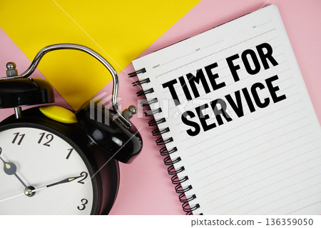 Time For Service text written on notepad with alarm clock on pink background 136359050