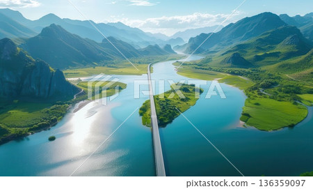 Aerial view of a winding river through a valley, surrounded by lush green mountains. Aerial view of a winding river through a valley, surrounded by lush green mountains. 136359097