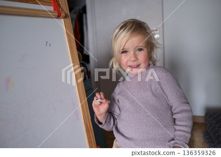 Smart preschool child pretending to be a teacher, early education and homeschooling concept. 136359326