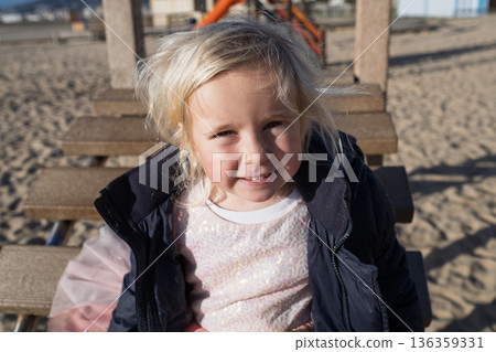 Cute 4 year old blonde girl walking outdoors in the park Cute 4 year old blonde girl walking outdoors in the park 136359331
