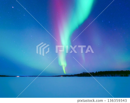 Panoramic horizontal view of the aurora borealis dancing over a frozen lake in Scandinavia.  136359343