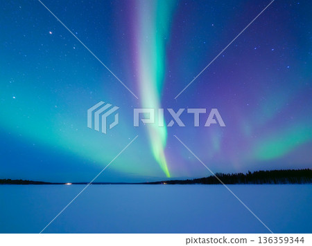 Panoramic horizontal view of the aurora borealis dancing over a frozen lake in Scandinavia. Panoramic horizontal view of the aurora borealis dancing over a frozen lake in Scandinavia. 136359344