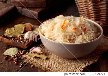 Homemade sauerkraut with carrot on an old wooden table. Homemade sauerkraut with carrot on an old wooden table. 136359771