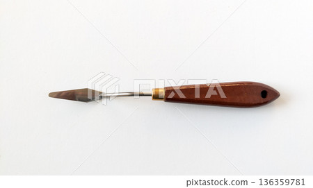 Palette knife with wooden handle. Art supply for oil and acrylic painting isolated on a white background. Palette knife with wooden handle. Art supply for oil and acrylic painting isolated on a white background. 136359781