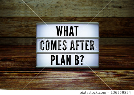 Lightbox with text "What Comes After Plan B?" on wooden background 136359834