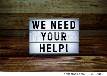 Lightbox with text "We Need Your Help!" on wooden background Lightbox with text "We Need Your Help!" on wooden background 136359836