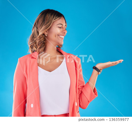 Happy, choice and presentation with woman and space in studio for decision, show and information. Offer, advertising and deal with face of person on blue background for thinking, option and mockup Happy, choice and presentation with woman and space in studio for decision, show and information. Offer, advertising and deal with face of person on blue background for thinking, option and mockup 136359977