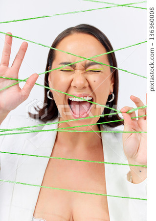 Makeup, fashion and strings with woman screaming in studio for creative, art and cosmetics. Abstract, cotton and texture with face of model on white background for designer, shouting and textile Makeup, fashion and strings with woman screaming in studio for creative, art and cosmetics. Abstract, cotton and texture with face of model on white background for designer, shouting and textile 136360008