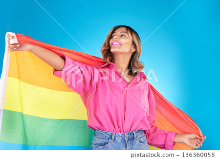 Lgbtq, lesbian and woman with support, pride flag or equality on blue studio background. Female person, rainbow or model with symbol for queer community, transgender rights or freedom with self love 136360058