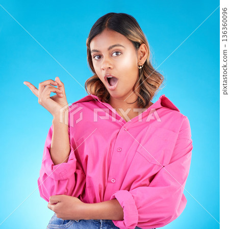 Surprise, pointing and space with portrait of woman in studio for news, presentation or idea. Wow, shocked and promotion with person on blue background for information, choice and announcement mockup Surprise, pointing and space with portrait of woman in studio for news, presentation or idea. Wow, shocked and promotion with person on blue background for information, choice and announcement mockup 136360096