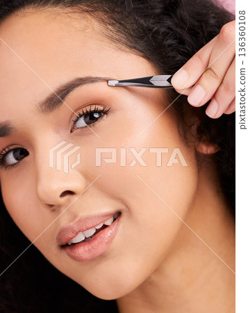 Face, closeup and woman with tweezer for eyebrow, beauty and grooming for skincare. Natural portrait, facial plucking and hair removal of model for self care, wellness or aesthetic for cosmetics. 136360108