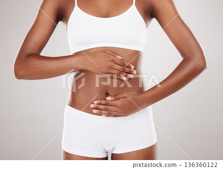 Body, hands and stomach of a woman for health and wellness on a white studio background. Fitness, gut and diet of aesthetic female model for weight loss, colon balance or digestion and motivation Body, hands and stomach of a woman for health and wellness on a white studio background. Fitness, gut and diet of aesthetic female model for weight loss, colon balance or digestion and motivation 136360122