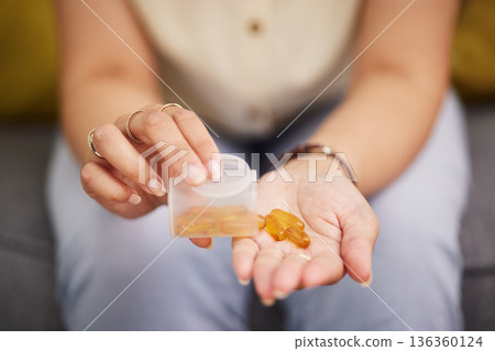 Hands, pills and a person with fish oil for health, wellness and medicine for diet. Closeup, bottle and a woman with medication or a healthcare supplement in the morning for medical goals or support Hands, pills and a person with fish oil for health, wellness and medicine for diet. Closeup, bottle and a woman with medication or a healthcare supplement in the morning for medical goals or support 136360124