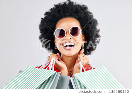 Happy black woman, face and shopping bags for fashion or style against a white studio background. Portrait of African female person, customer or shopper smile for discount, sale or deal in happiness Happy black woman, face and shopping bags for fashion or style against a white studio background. Portrait of African female person, customer or shopper smile for discount, sale or deal in happiness 136360130
