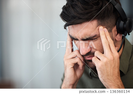 Telemarketing, call center and man with a headache, burnout and tech support with stress, pain and overtime. Male person, employee or consultant with a migraine, health fatigue and agent with tension 136360134