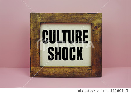 Culture Shock text with brown wooden frame on pink background 136360145
