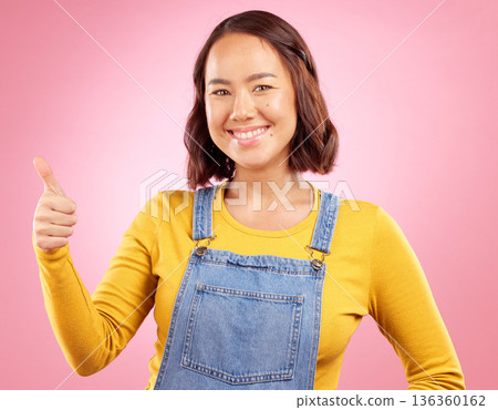 Happy, thumbs up and yes with portrait of woman in studio for support, agreement and motivation. Winner, emoji and success with person on pink background for achievement, thank you and vote sign 136360162