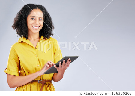 Smile, email and portrait of a woman with a tablet on a studio background for communication. Happy, work and a young girl or employee typing on technology with mockup space for an app or internet 136360203