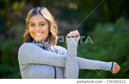 Nature, sports and portrait of a woman stretching her arms for an outdoor workout or training. Fitness, happy and young female athlete doing a warm up exercise in a park for cardio running in garden. 136360221