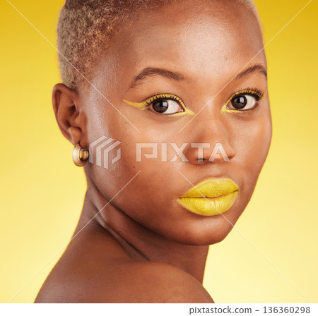 Beauty, makeup and portrait of a woman in a studio with eyeliner and lipstick for cosmetology. Self care, cosmetic and young African female model with a colorful face routine by a yellow background. 136360298