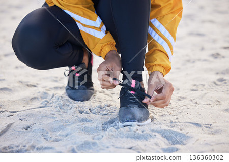 Beach, closeup and woman tie shoes for an outdoor run for fitness, health and wellness by seaside. Sports, athlete and zoom of female runner tying laces for a cardio workout or exercise by the ocean. 136360302