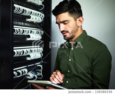 Engineer man, cable and tablet in server room for programming, maintenance and software upgrade. Serious technician person with technology in data center for wire, hardware and internet connection 136360336