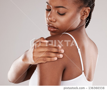 Black woman, shoulder pain and injury with health risk, muscle tension and stress on a grey studio background. Female person, inflammation or model with joint strain, sore and swollen with body ache Black woman, shoulder pain and injury with health risk, muscle tension and stress on a grey studio background. Female person, inflammation or model with joint strain, sore and swollen with body ache 136360338
