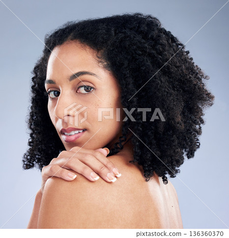 Skin, beauty and a woman with hand on shoulder for dermatology, cosmetics and natural makeup. Portrait of African female model on a studio background for self care, glow and soft touch with manicure 136360370