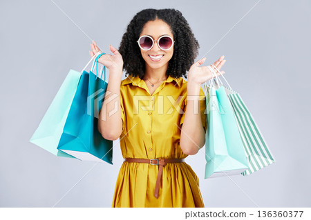 Sunglasses, portrait and happy woman with shopping bag for fashion in studio isolated on a white background. Cool, sales and African customer with gift, discount deal and stylish clothes from store Sunglasses, portrait and happy woman with shopping bag for fashion in studio isolated on a white background. Cool, sales and African customer with gift, discount deal and stylish clothes from store 136360377