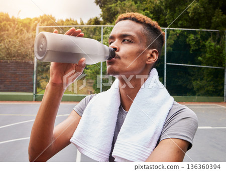Outdoor, fitness and man with water, training or body recovery with exercise, workout goal or tired. Healthy person, exhausted or African athlete with liquid, hydration or thirsty on court for sports Outdoor, fitness and man with water, training or body recovery with exercise, workout goal or tired. Healthy person, exhausted or African athlete with liquid, hydration or thirsty on court for sports 136360394