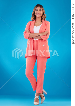 Corporate, crossed arms and portrait of business woman in studio confident for career, job and startup. Professional, fashion and female person with confidence, pride and ambition on blue background 136360417