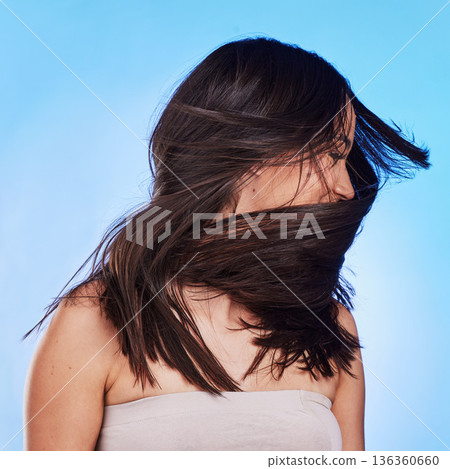 Woman, shake hair and beauty with growth, shine and self care against a blue studio background. Natural cosmetics, female person or model satisfied with salon treatment, glow and health with wellness Woman, shake hair and beauty with growth, shine and self care against a blue studio background. Natural cosmetics, female person or model satisfied with salon treatment, glow and health with wellness 136360660
