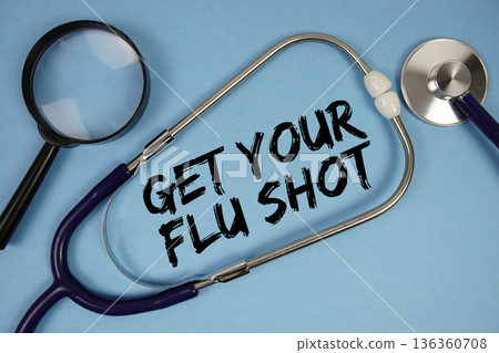 Get Your Flu Shot text with Stethoscope and magnifying glass on blue background 136360708