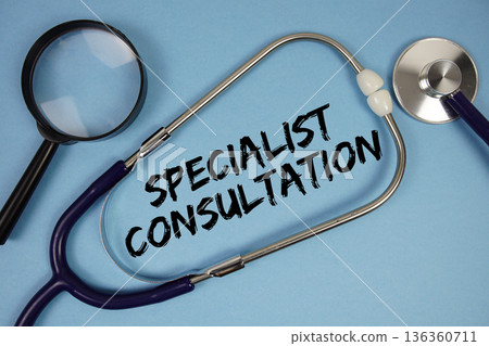 Specialist Consultation text with Stethoscope and magnifying glass on blue background 136360711