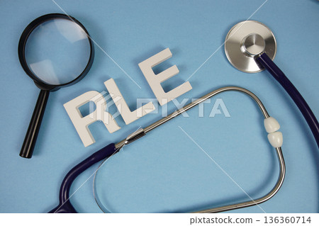 RLE Right Lower Extremity text with Stethoscope and magnifying glass on blue background 136360714