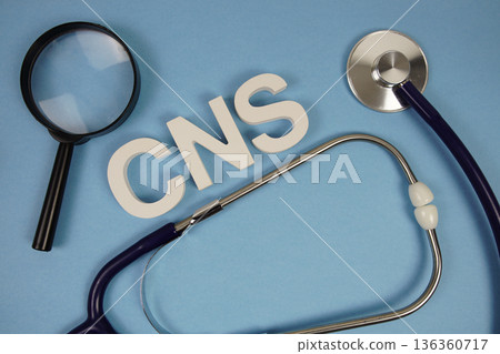 CNS abbreviation of Central Nervous System alphabet letters with magnifying glass and stethoscope on blue background 136360717