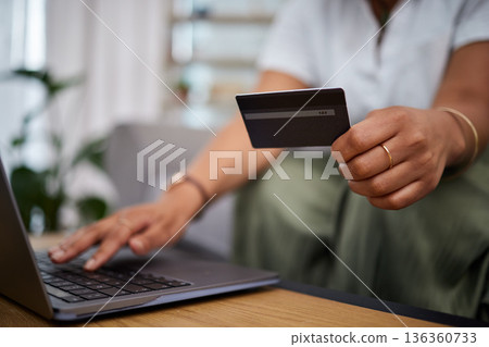 Woman, laptop and hands with credit card in ecommerce, payment or fintech banking on sofa at home. Closeup female person or shopper with debit on computer app in online shopping, purchase or buying Woman, laptop and hands with credit card in ecommerce, payment or fintech banking on sofa at home. Closeup female person or shopper with debit on computer app in online shopping, purchase or buying 136360733