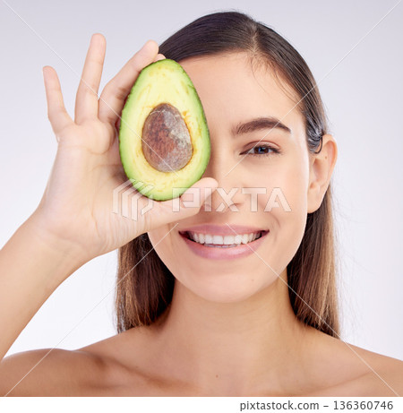 Face, skincare and woman smile with avocado for beauty cosmetics isolated on a white background in studio. Portrait, happy and natural model with fruit food for nutrition, healthy diet or wellness Face, skincare and woman smile with avocado for beauty cosmetics isolated on a white background in studio. Portrait, happy and natural model with fruit food for nutrition, healthy diet or wellness 136360746