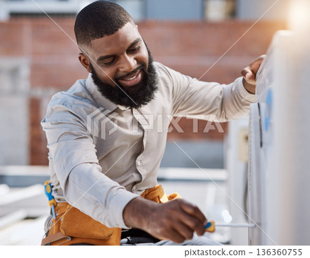 Building, engineer and air conditioner install with a black man on a roof for construction or manual labor. Industrial, engineering and an electrician working on ac repair for maintenance or service 136360755